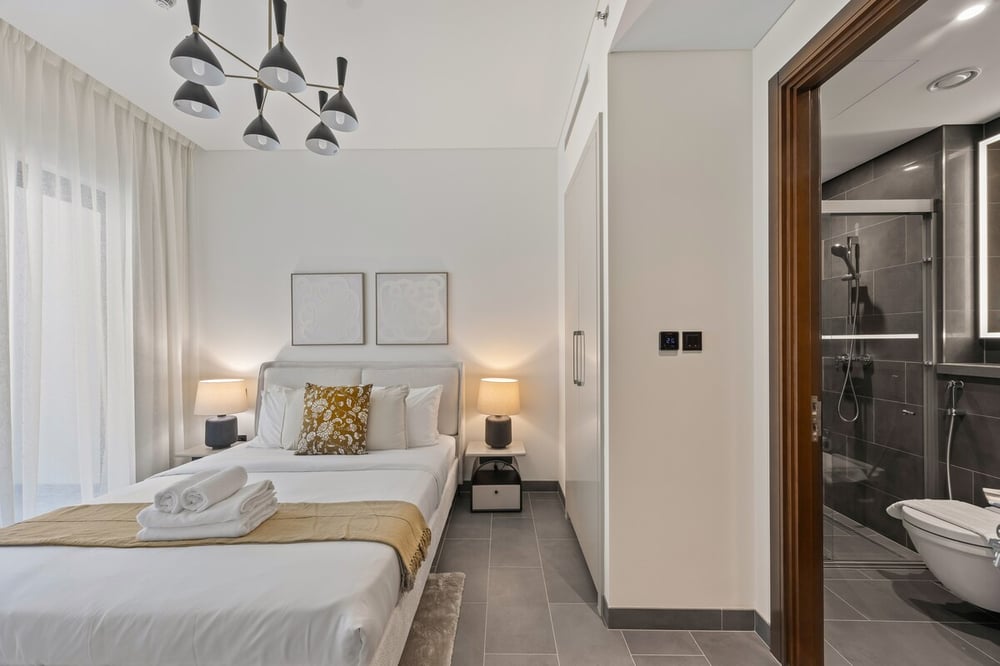 Bedroom with double bed wardrobe and en-suite bathroom glimpse
