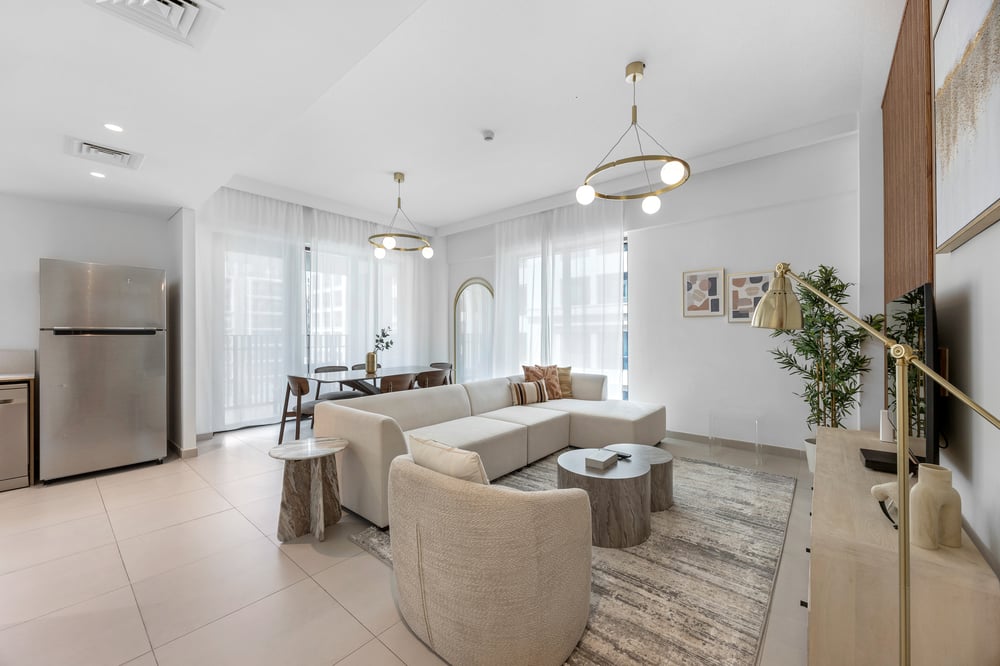 Open living area with sofa corner seating and kitchen view