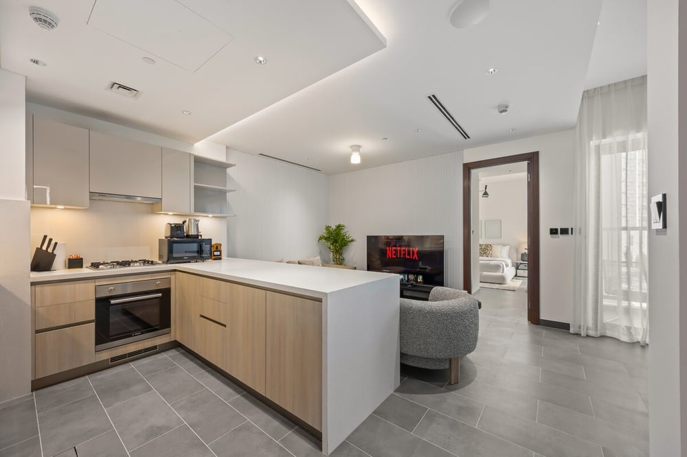 Kitchen with oven and peninsula open to living area