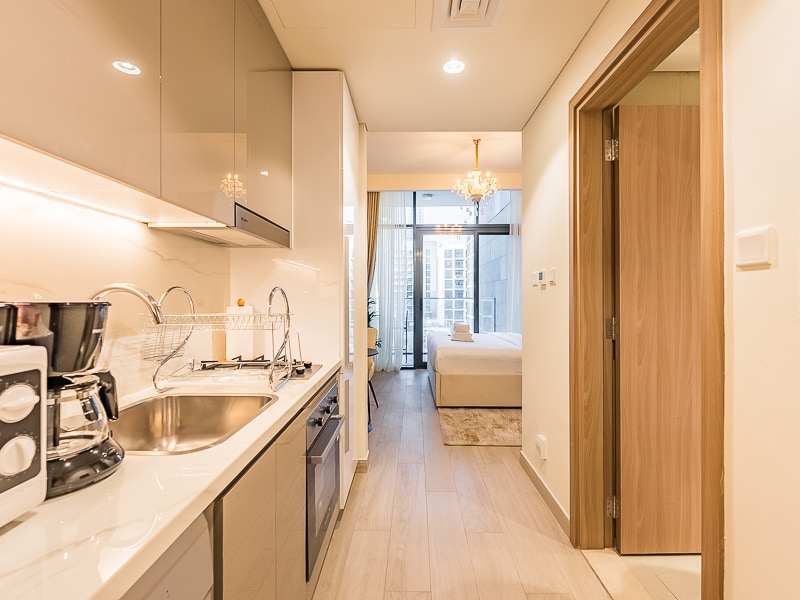Studio open-plan kitchen area with view toward sleeping area