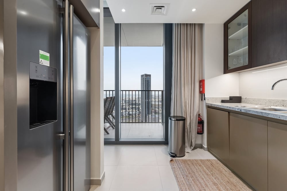 Kitchen with balcony access and dark cabinetry