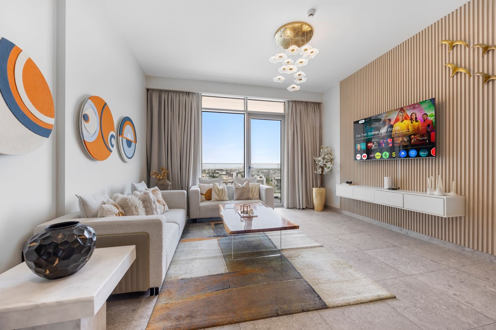 Living room with TV wall unit and balcony view