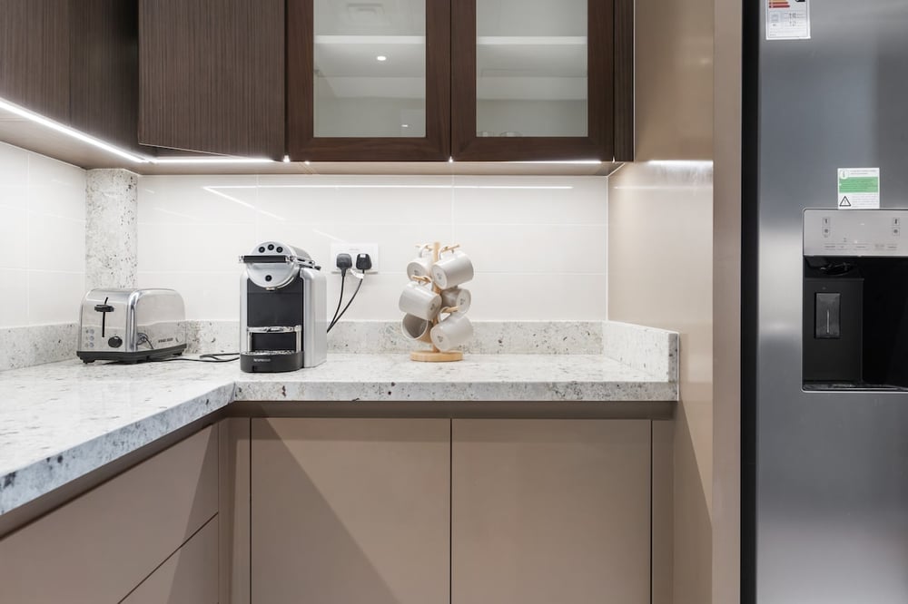 Kitchen counter with marble top, toaster and coffee machine