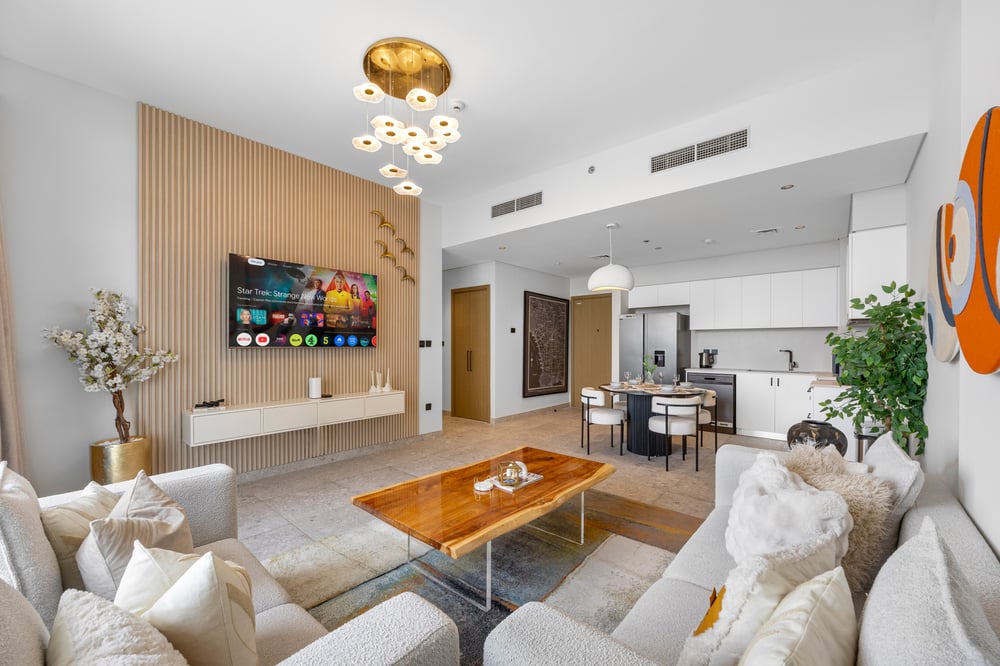 Living room with white sofas and TV wall unit