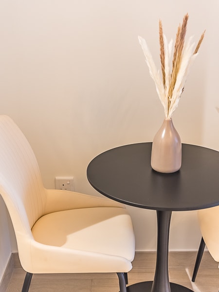 Small round dining table with two chairs