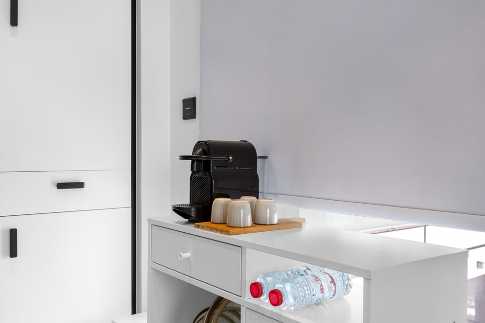Coffee machine and water bottles on kitchen counter