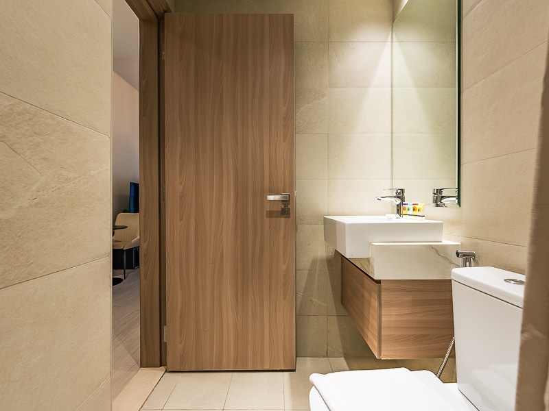 Bathroom with sink, toilet and wooden vanity