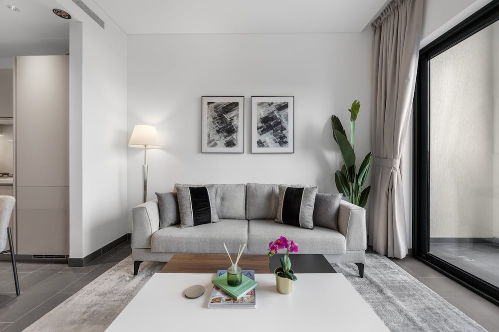 Living room seating area with sofa and floor lamp