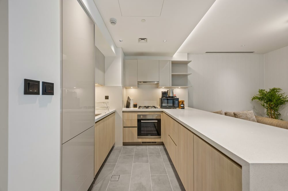 Full kitchen with wooden cabinets oven and counter