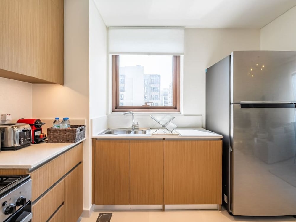 Kitchen with fridge sink and city view window