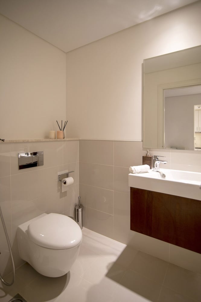 Second bathroom with wall-hung toilet and vanity unit