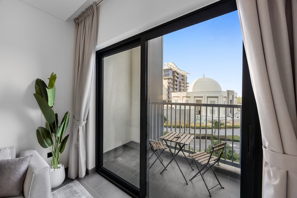 Balcony with bistro table and chairs and city view