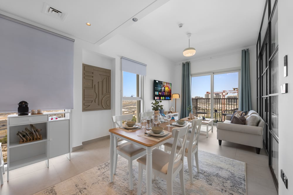 Living and dining area with set dining table and sofa