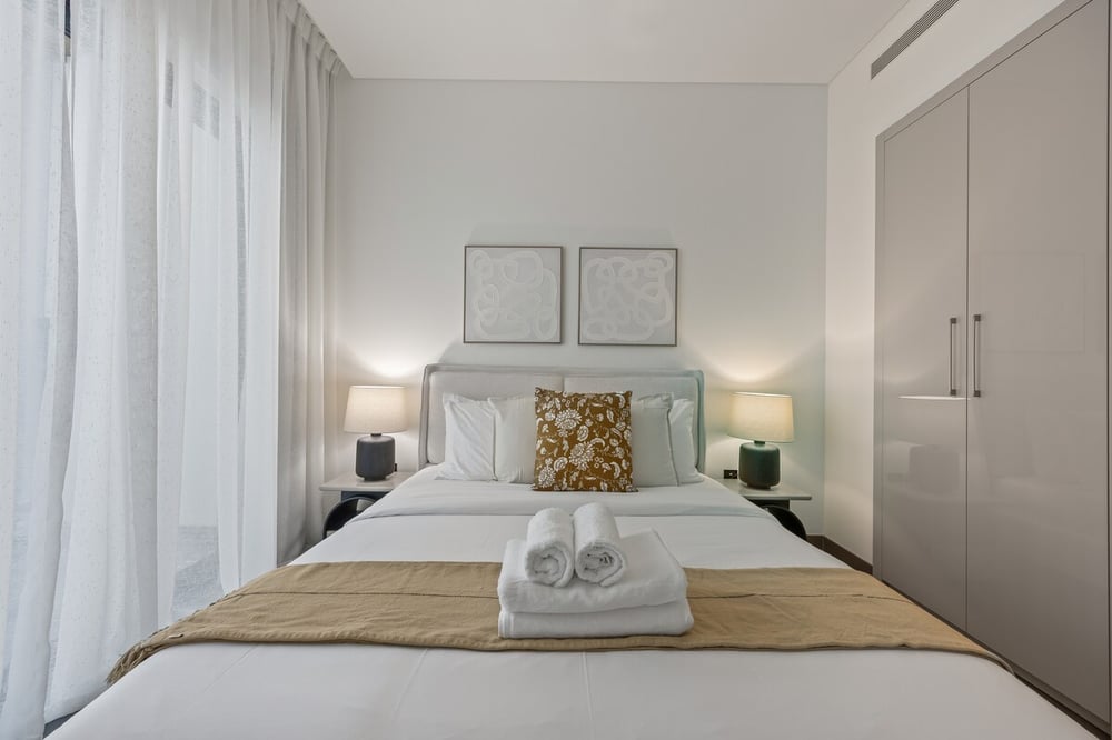 Bedroom with double bed wardrobe and artwork