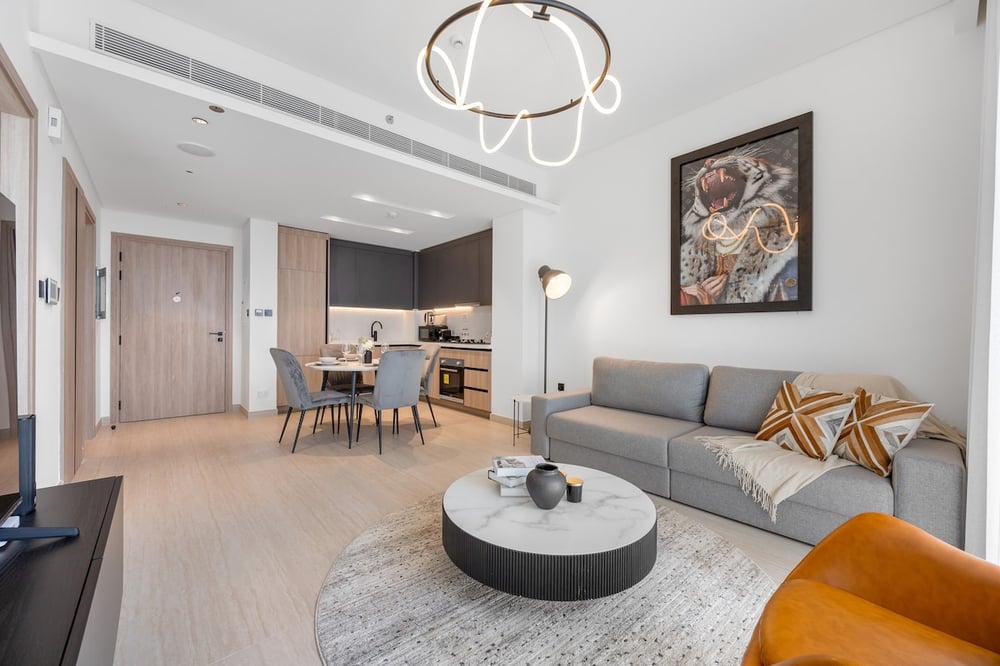 Open-plan living room with kitchen and dining area in background