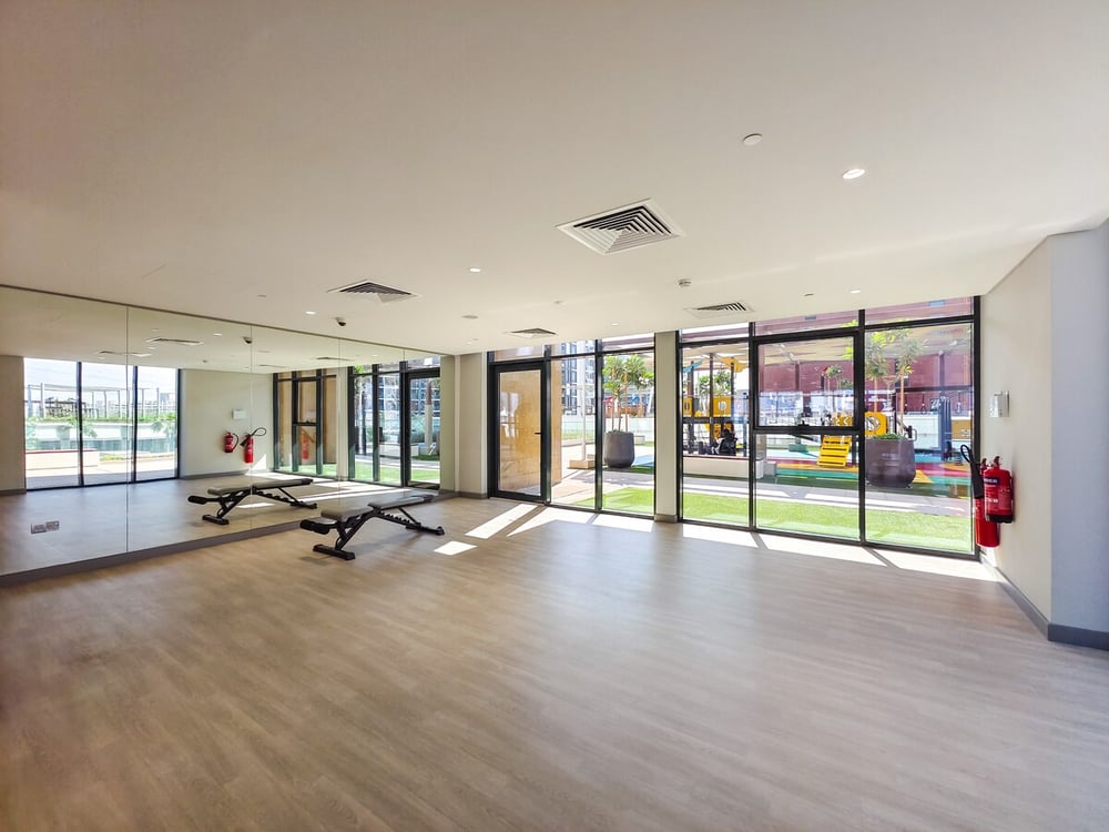 Building gym with exercise benches and large windows