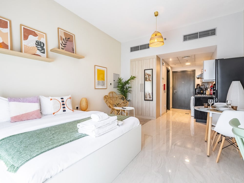 Studio open-plan space with bed fridge and kitchen