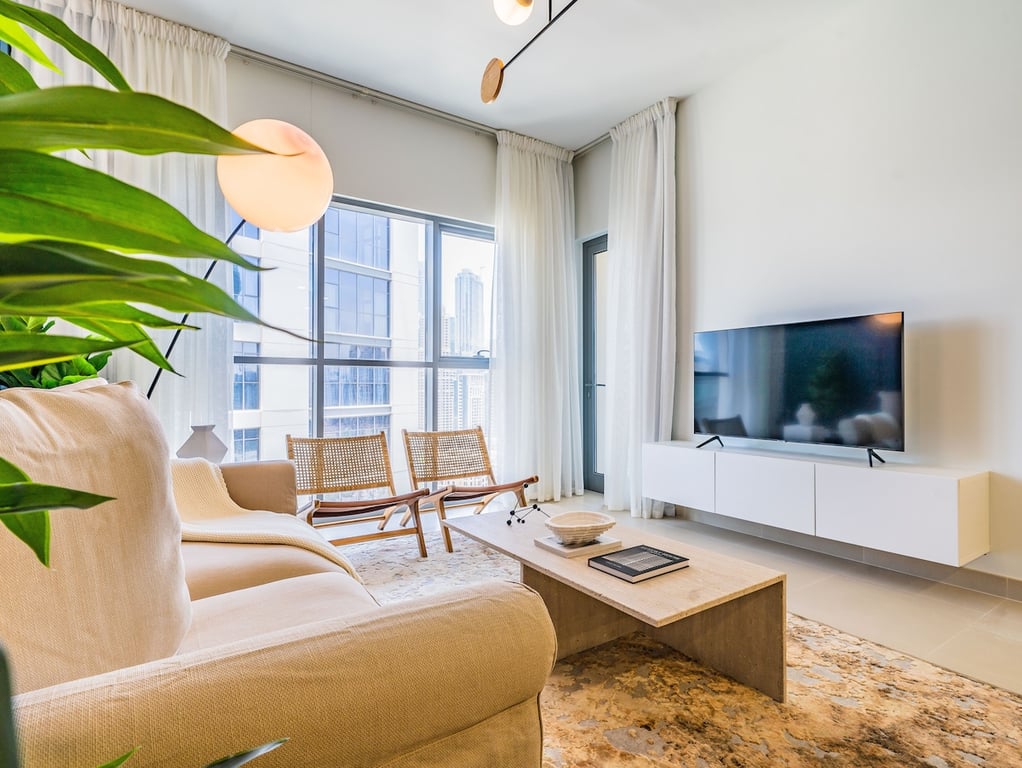 Living room with sofa TV and large window