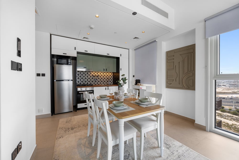 Open-plan living and dining area with kitchen in background