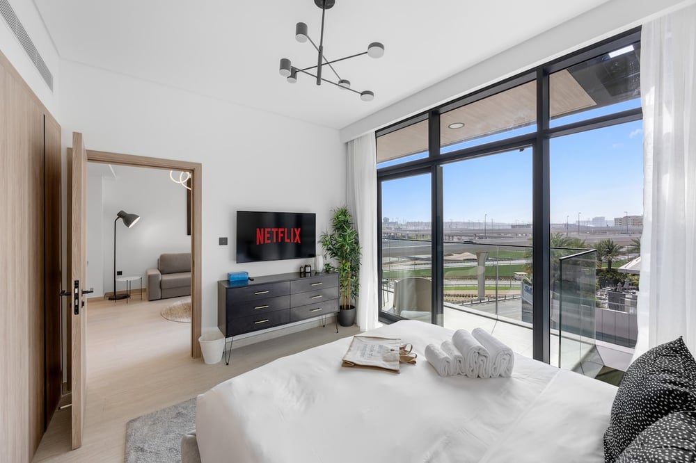 Bedroom with double bed, Netflix TV and large balcony windows