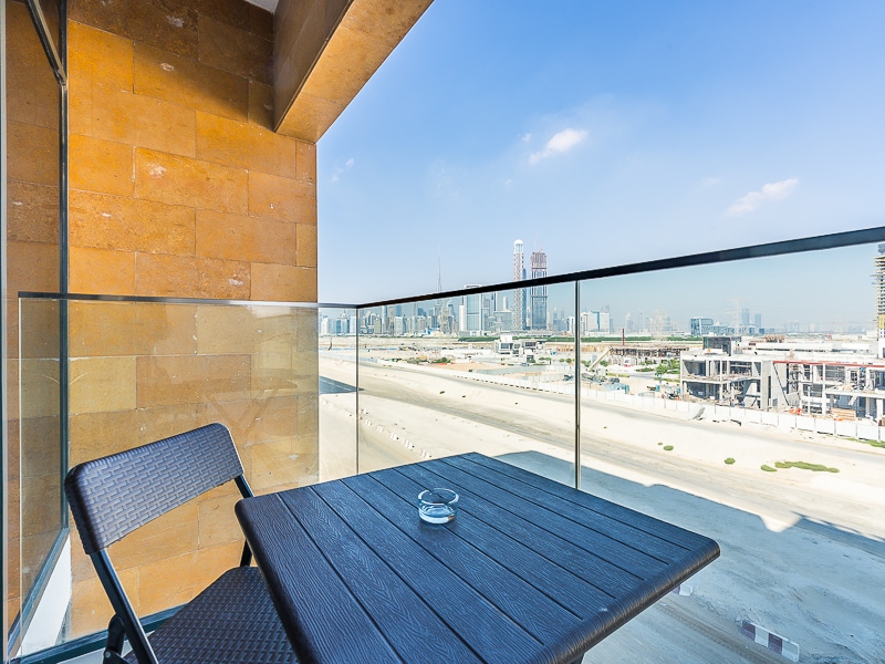 Balcony with outdoor seating and city skyline view