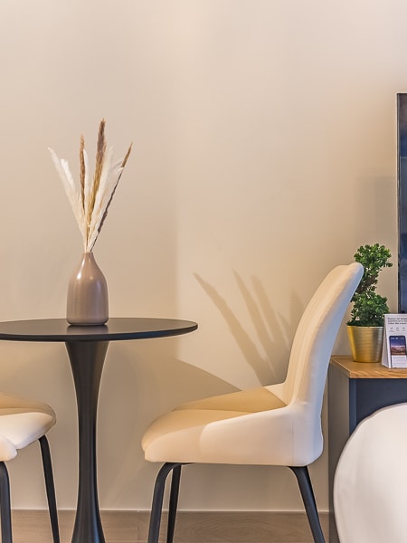 Dining area with table, chairs and TV unit visible