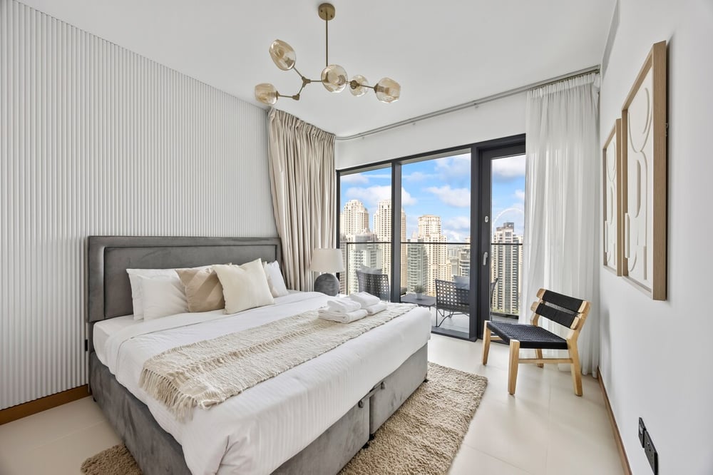Master bedroom with king bed and balcony access
