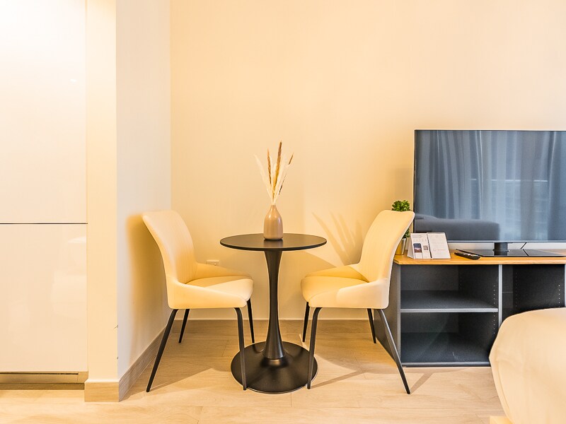Studio living-dining area with TV and dining table
