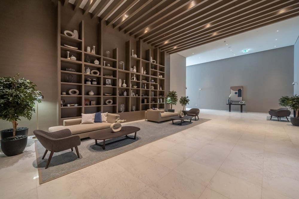 Building lobby corridor with decorative shelving and seating