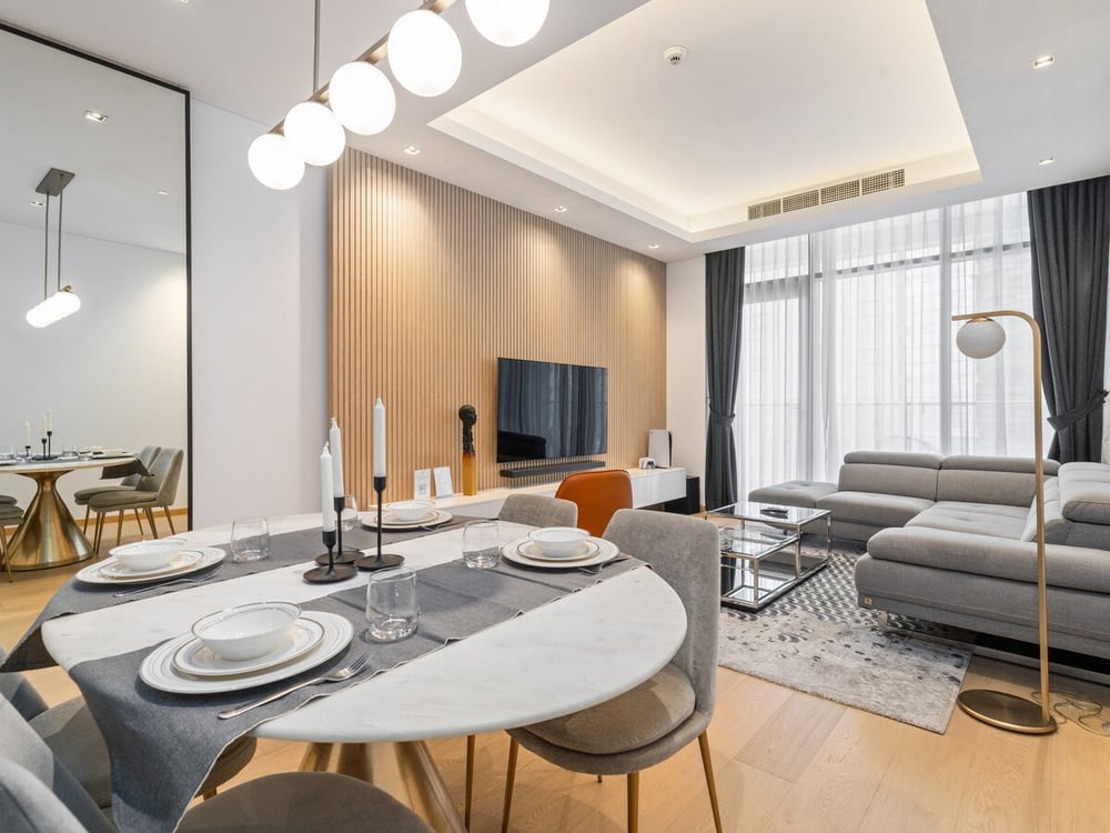 Open-plan living and dining room with TV and sofa