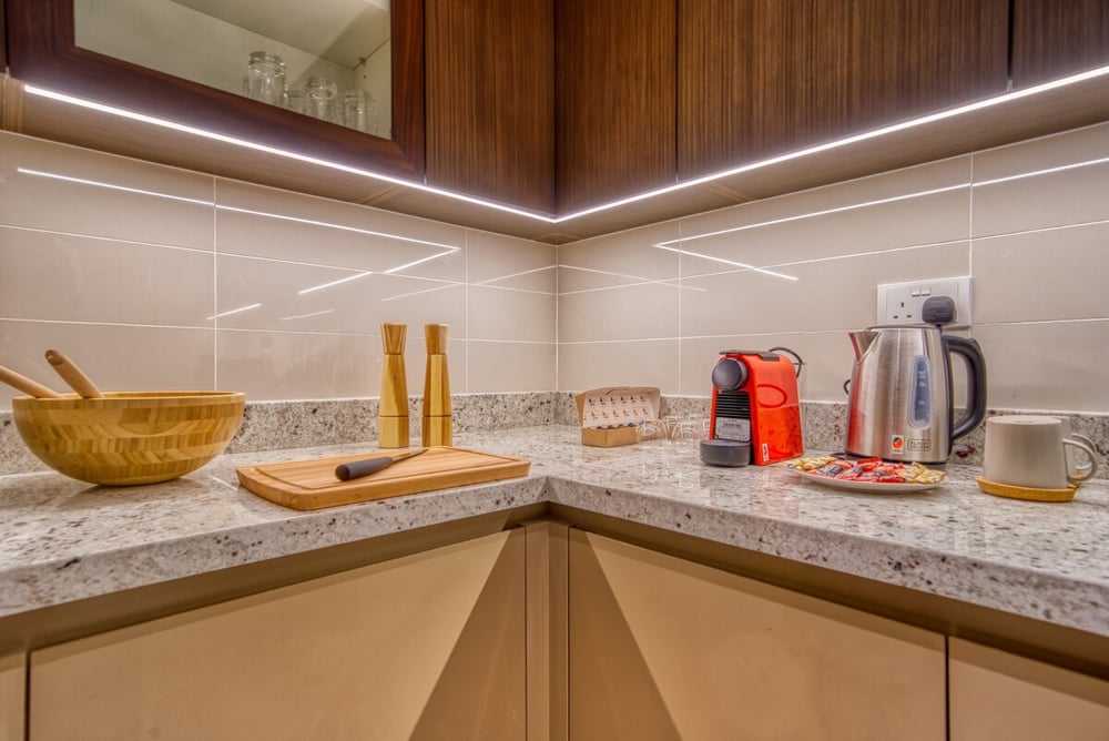 Kitchen corner with coffee maker, kettle and cutting board