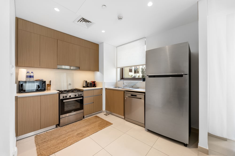 Kitchen with stainless steel appliances and wooden cabinetry