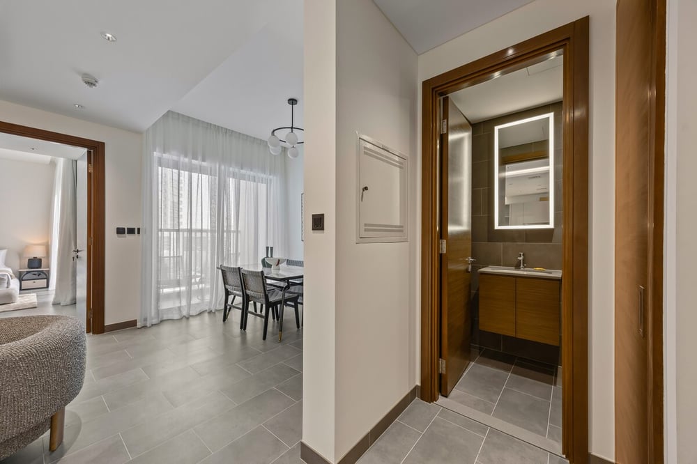 Hallway with view to dining area and open bathroom door