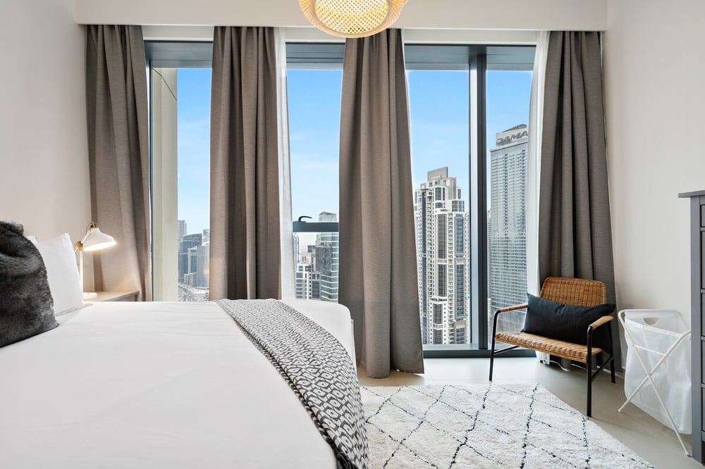 Bedroom with city view through floor-to-ceiling windows