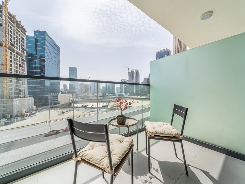 Balcony with two chairs and city skyline view