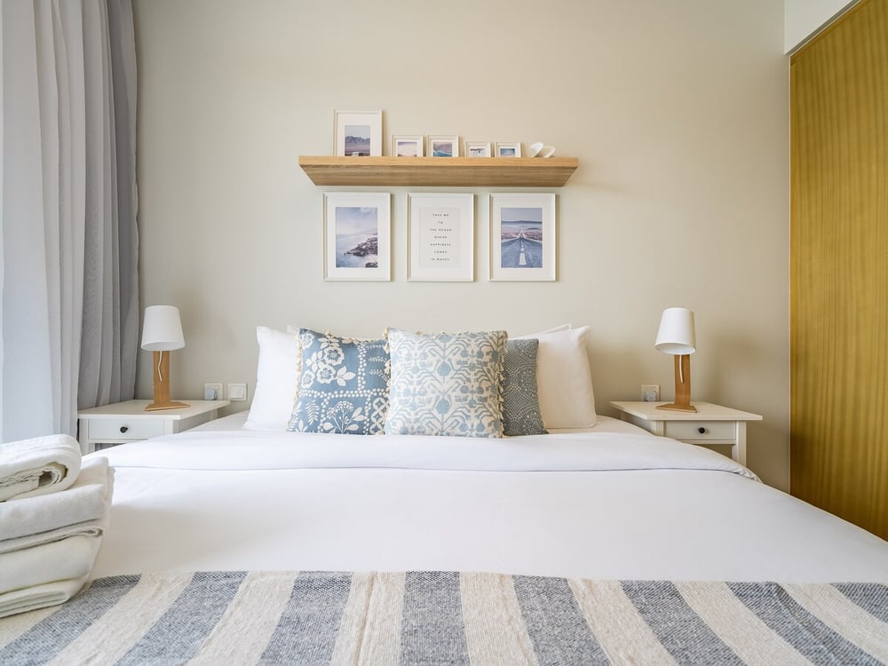 Bedroom with double bed, two nightstands and shelf above