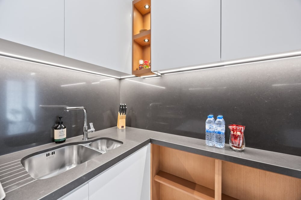Kitchen sink area with bottled water on counter