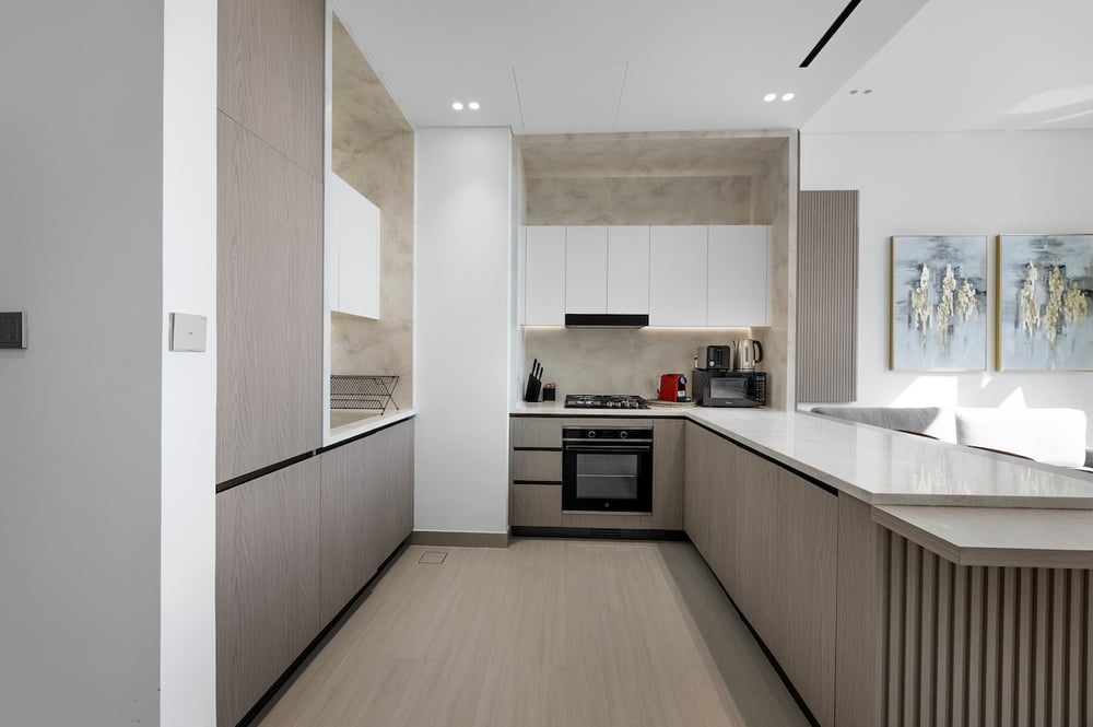 Kitchen with full cabinetry, oven and hood