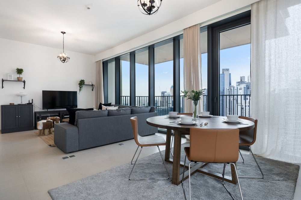 Open-plan living and dining area with TV and round table