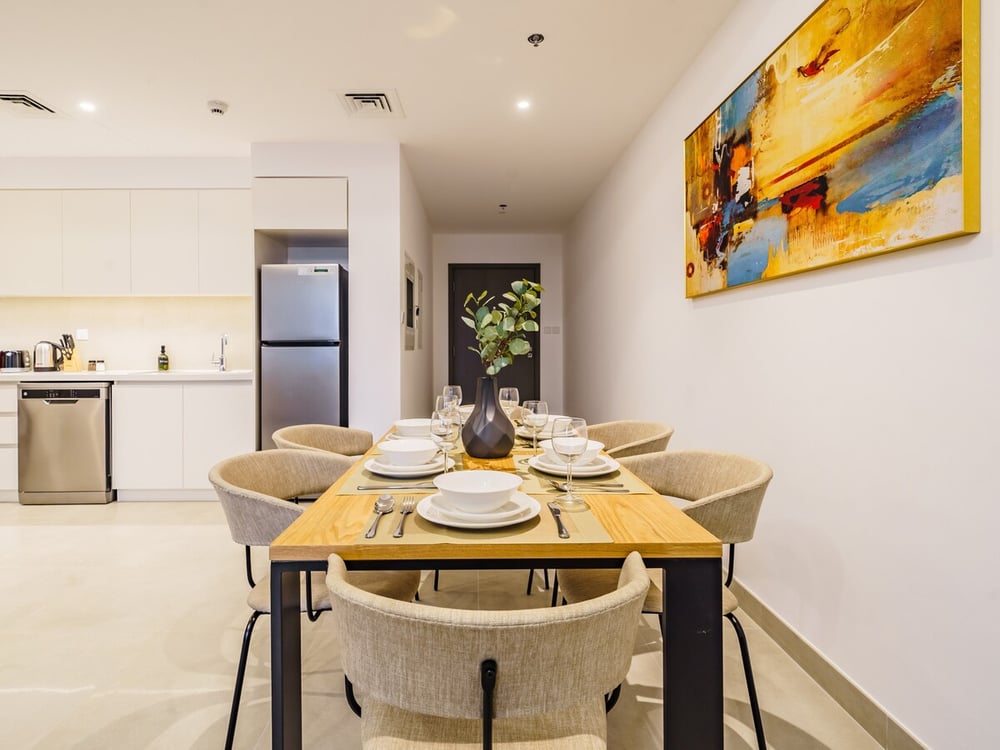 Dining area with wooden table and artwork on wall