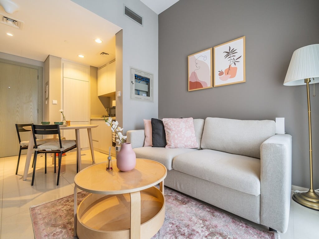 Open-plan living area with sofa dining table and kitchen beyond