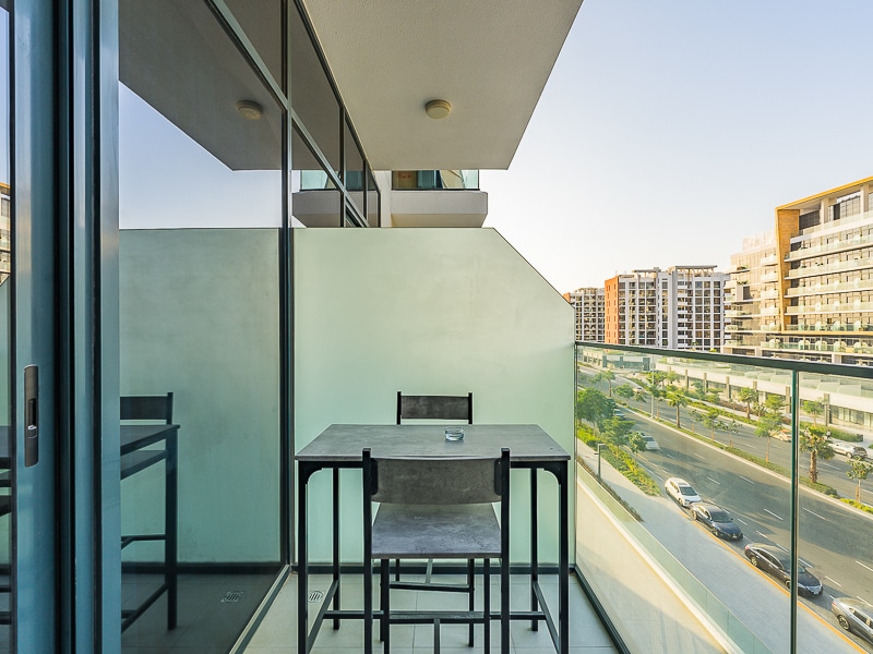 Balcony with table and chairs overlooking the street