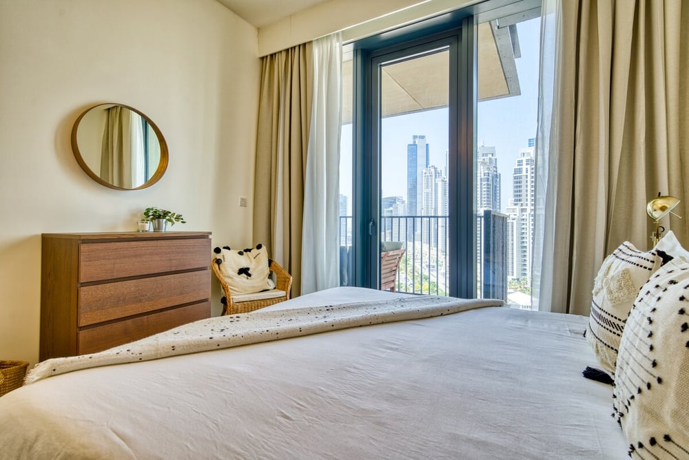 Bedroom with king bed, balcony and city view