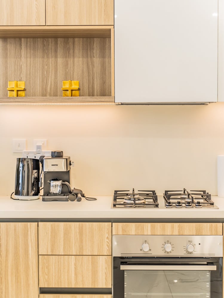 Kitchen counter with gas hob coffee maker and oven