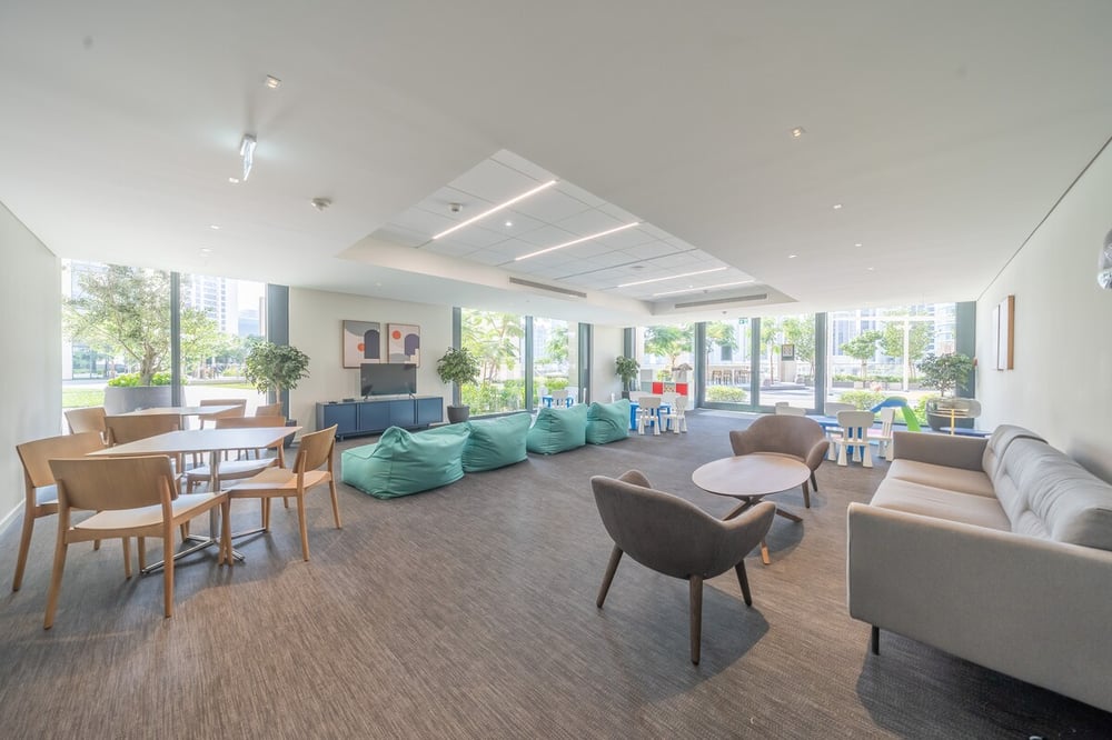 Building common lounge area with seating and large windows