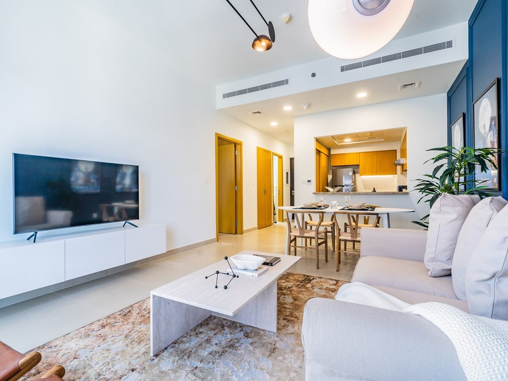 Open plan living room TV and kitchen visible