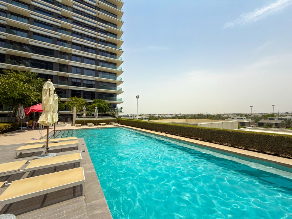 Outdoor swimming pool with sun loungers