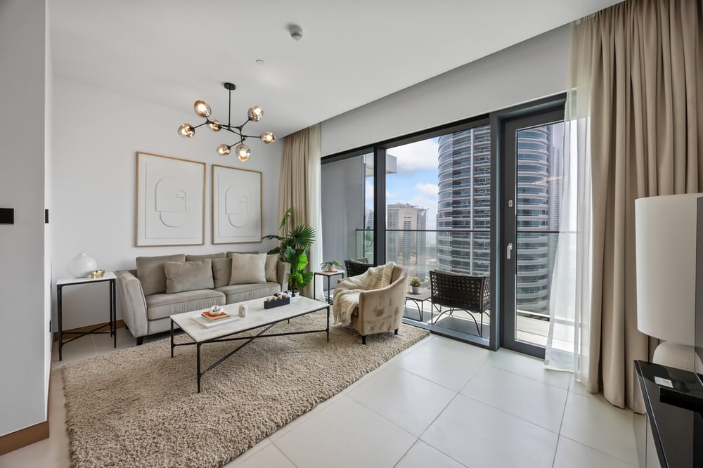 Living room with balcony access and city view