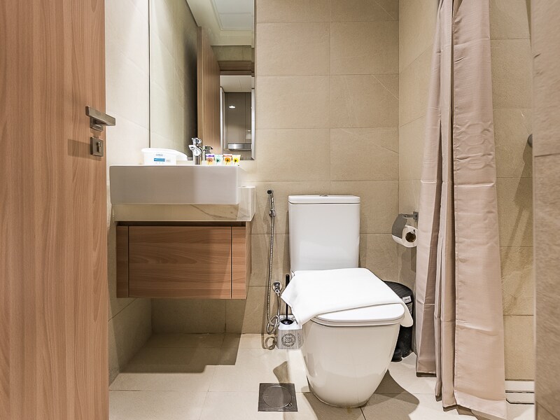 Full bathroom view with toilet, sink and shower
