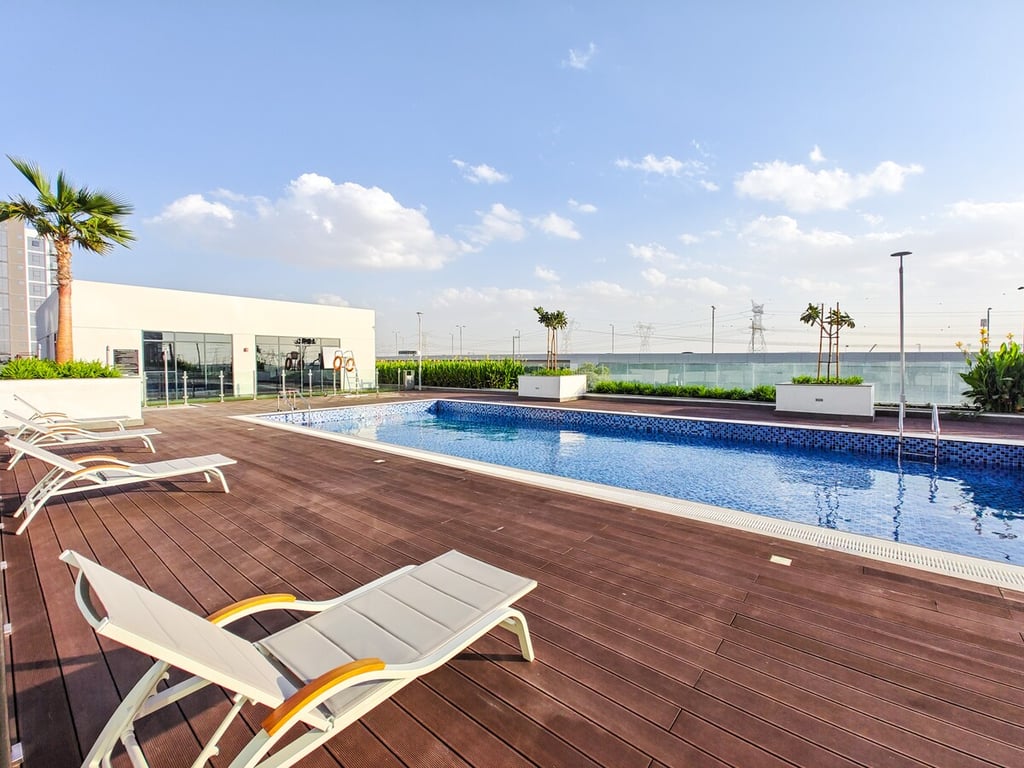 Rooftop outdoor pool with sun loungers and wooden deck